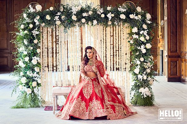 Saira Khan poses in traditional outfit with rose arch behind her