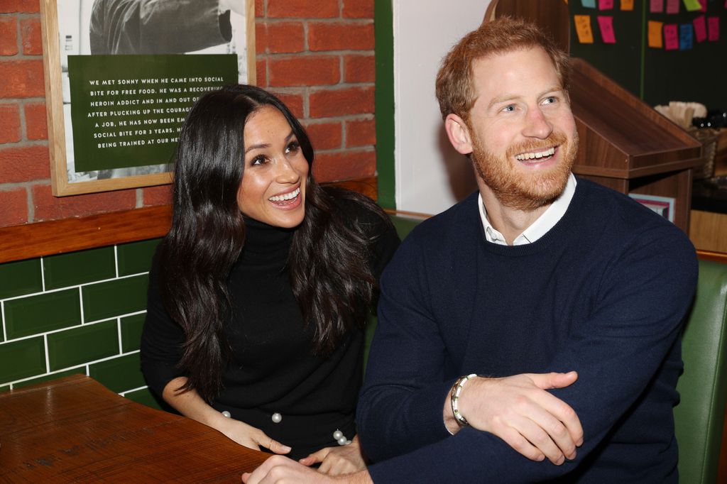 Harry and Meghan smiling in Edinburgh