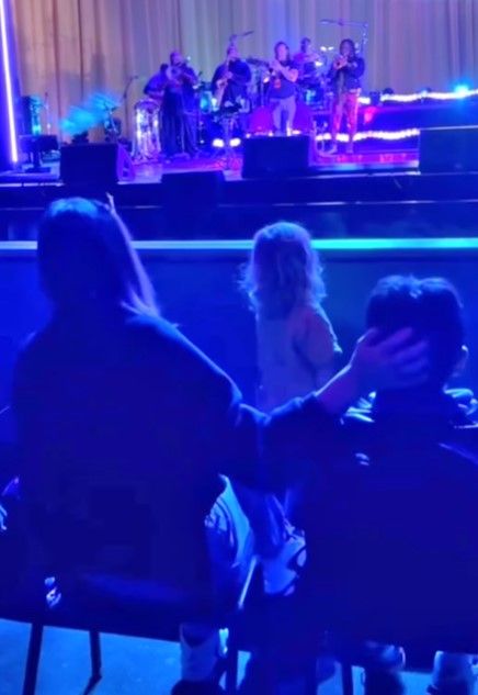 Jessica Biel placing a protective hand on son Silas head at concert 