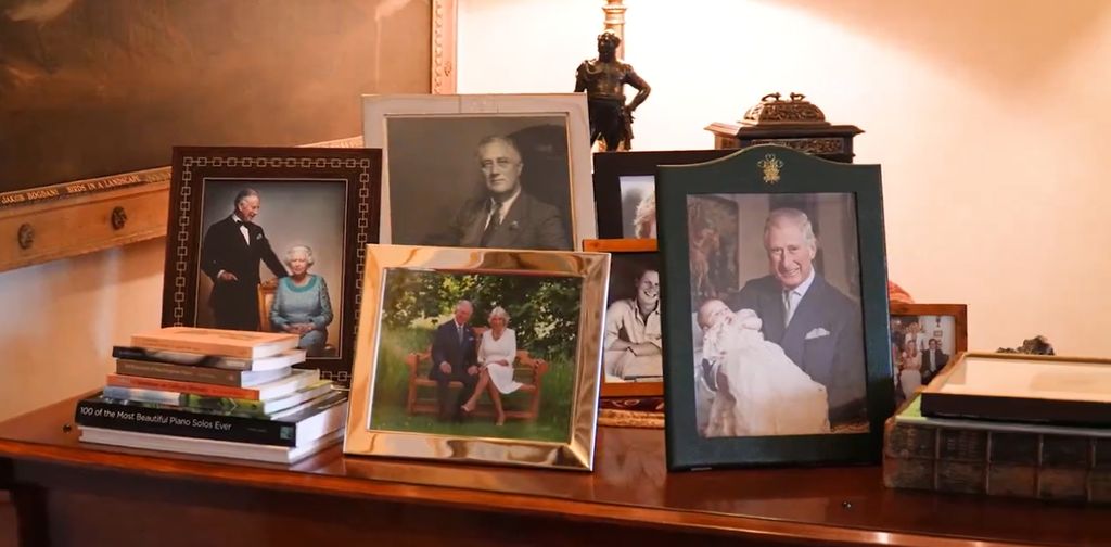 A selection of photos featuring the King holding a grandson, one of the King and late Queen and a black-and-white photo of Prince Harry