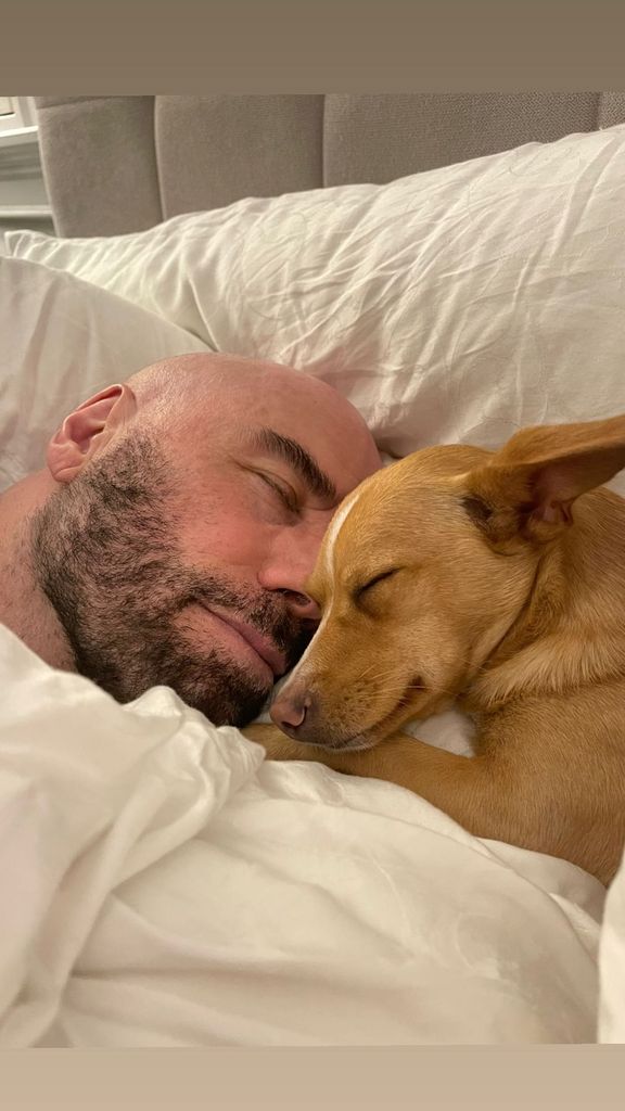 john travolta sleeping beside pet dog peanut
