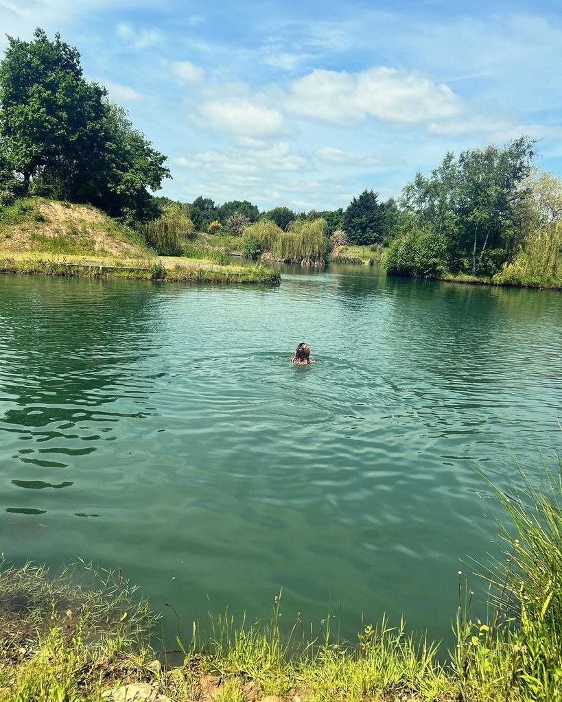 Charley Webb swimming in a lake