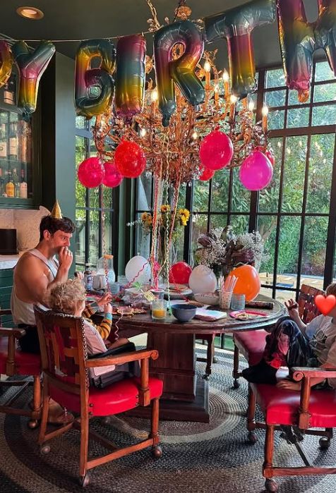 Tom Daley and his two sons sat around a dining table