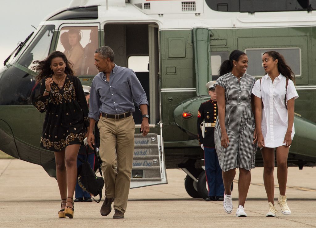 President Barack Obama, First Lady Michelle Obama and daughters Malia and Sasha walk to board Air Force One at Cape Cod Air Force Station in Massachusetts on August 21, 2016