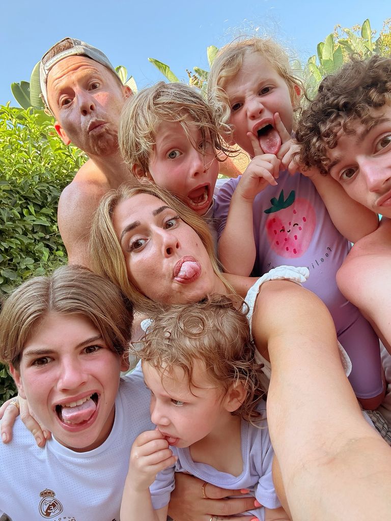 Stacey Solomon with five kids and husband joe swash pulling funny faces in selfie