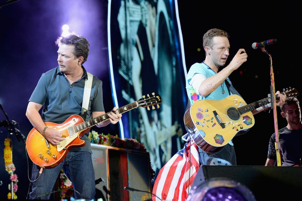 Actor Michael J. Fox (L) performs onstage with recording artist Chris Martin of Coldplay 