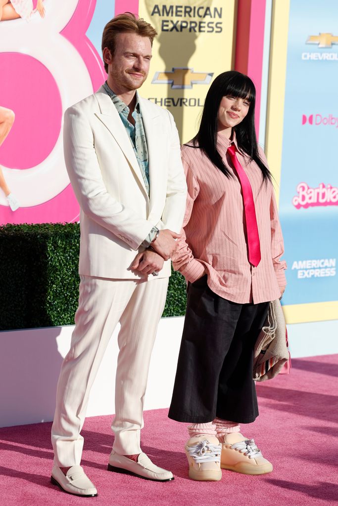 Billie Eilish smiling at the Barbie preimiere with her brother Finneas O'Connell 