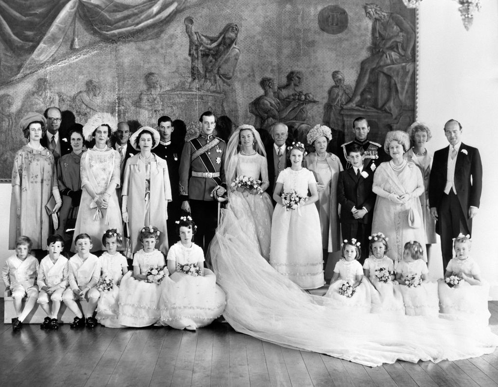 bride and groom in black and white with bridal party on either side