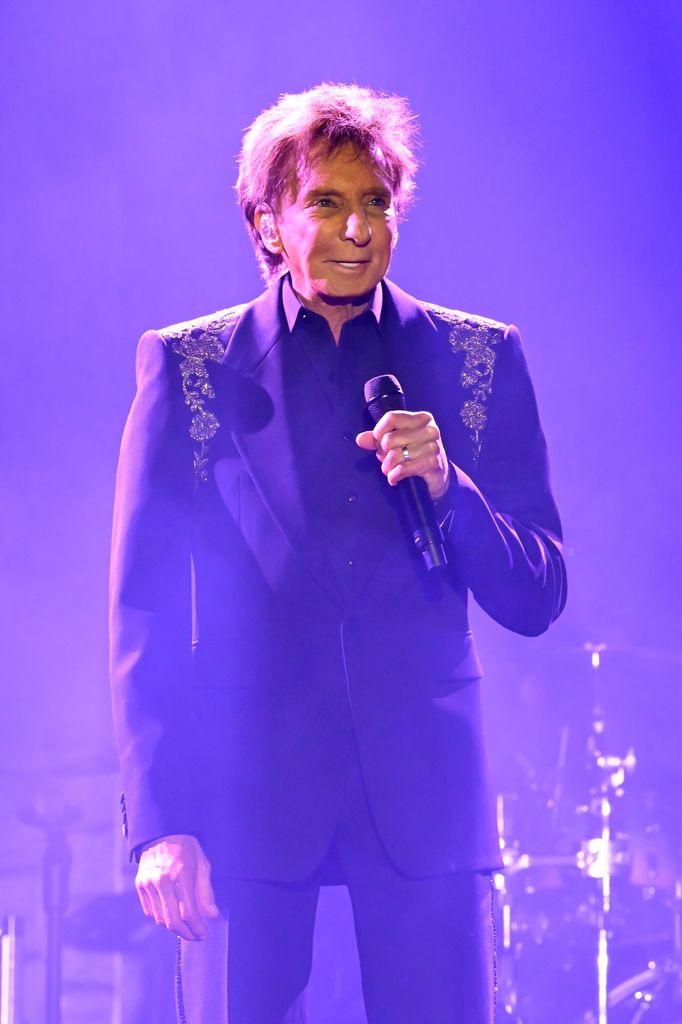 photo of barry manilow holding mic on stage