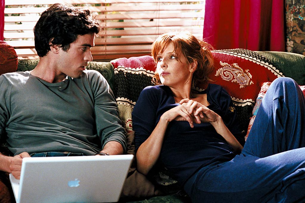 man and woman sitting on the sofa