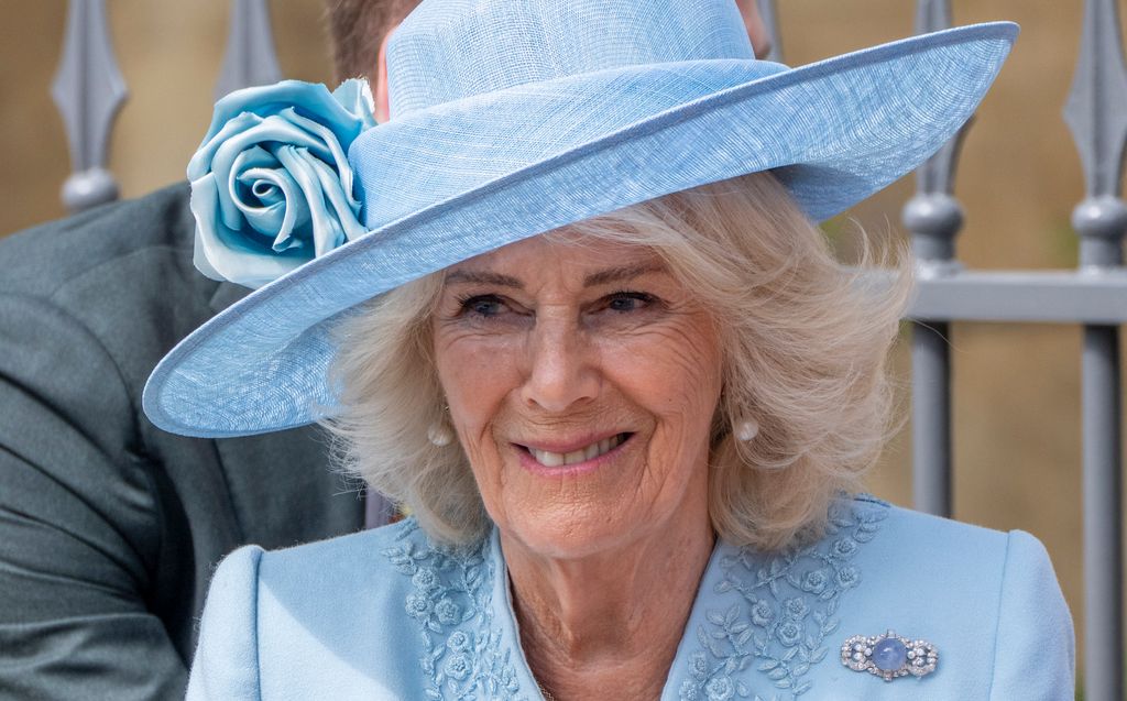 Queen Camilla wearing blue hat and coat