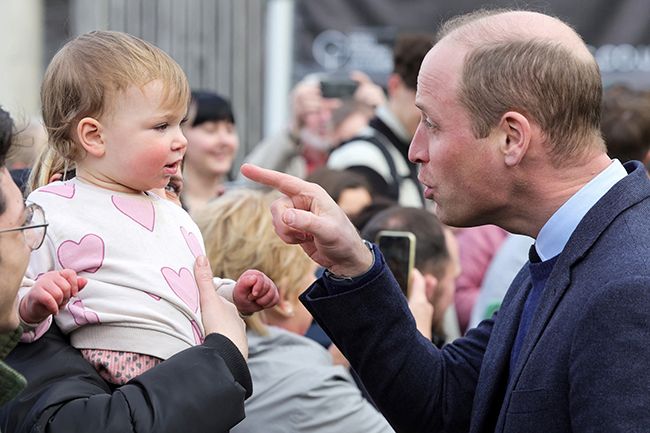 prince william pointing at curious baby girl in cornwall