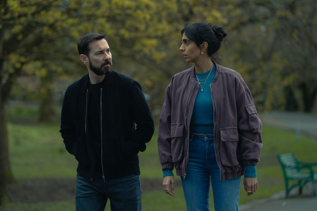 Man and woman walking in park