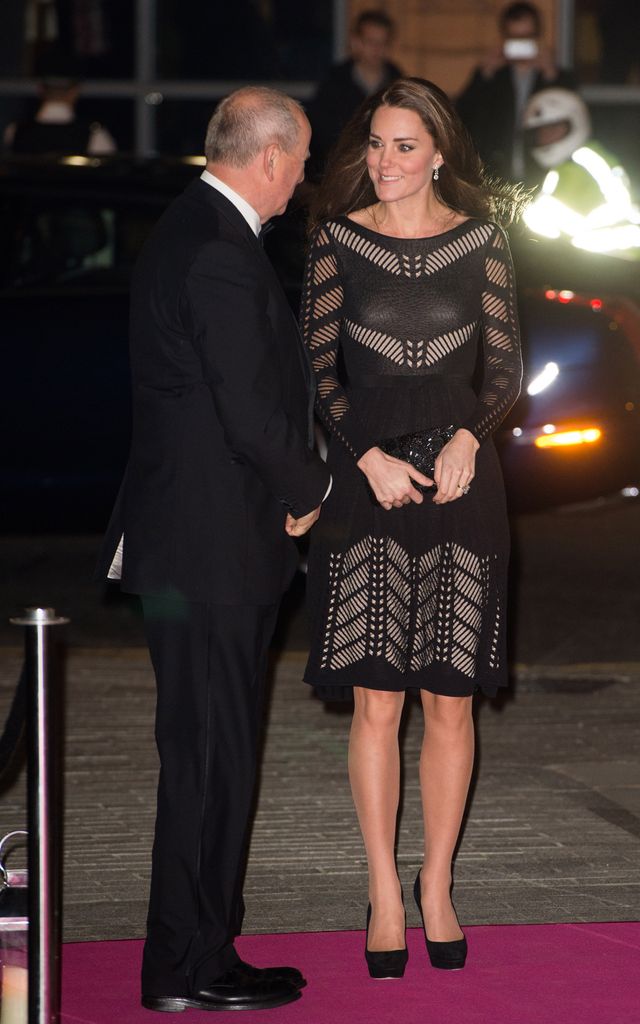 Kate talking to man outside event in black cutout dress