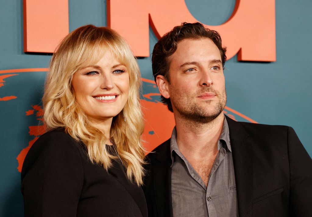 The loved-up couple  smile together on red carpet