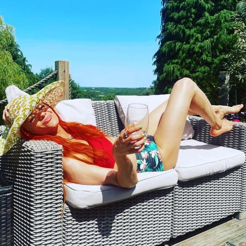 Dianne Buswell posing on a lounger outside 