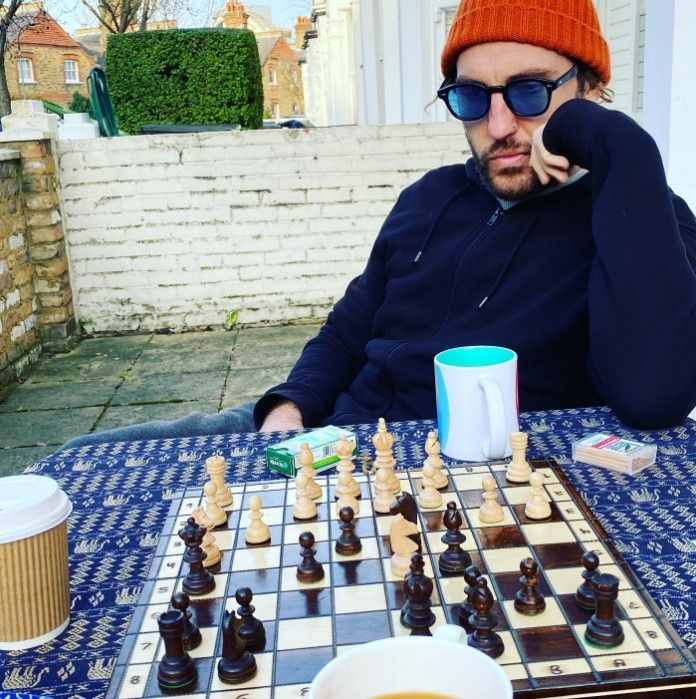 seann walsh playing chess in garden