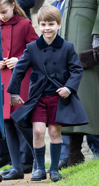 prince louis wearing navy coat and red shorts at sandringham