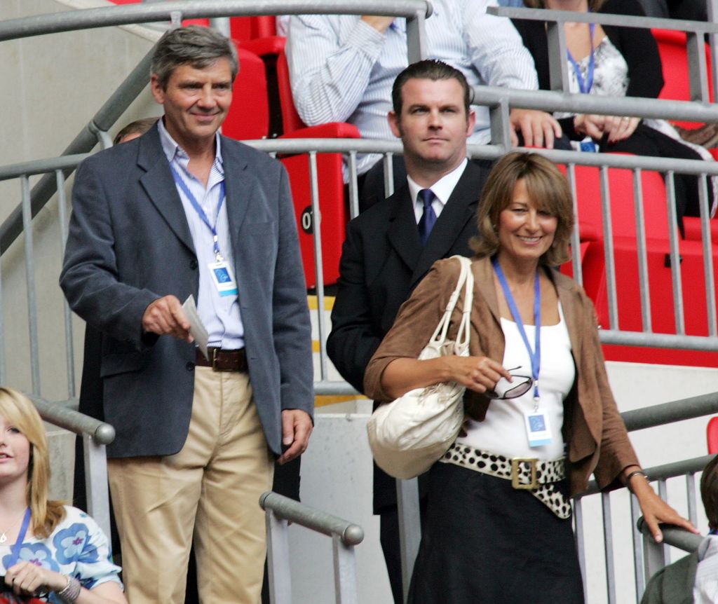 Carole Middleton wearing a wide belt and low slung skirt smiling with Michael