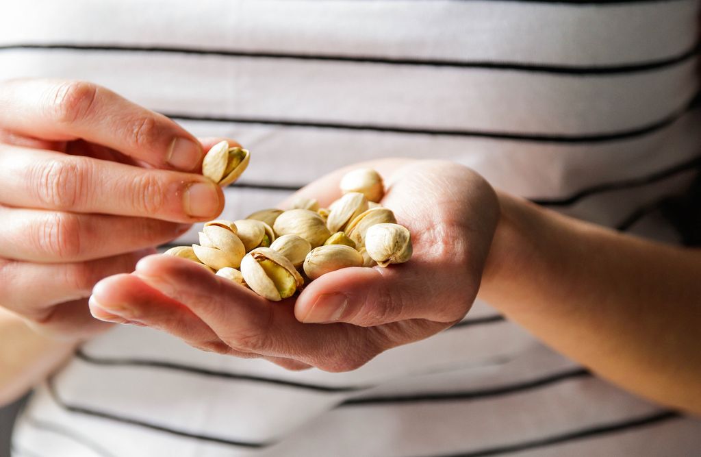 Pistachios close up in hand