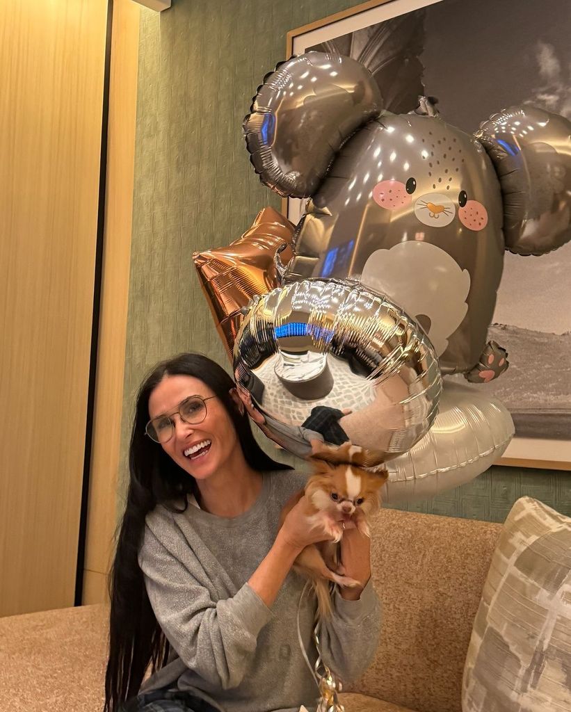 Demi celebrates turning 62 with her pup Pilaf