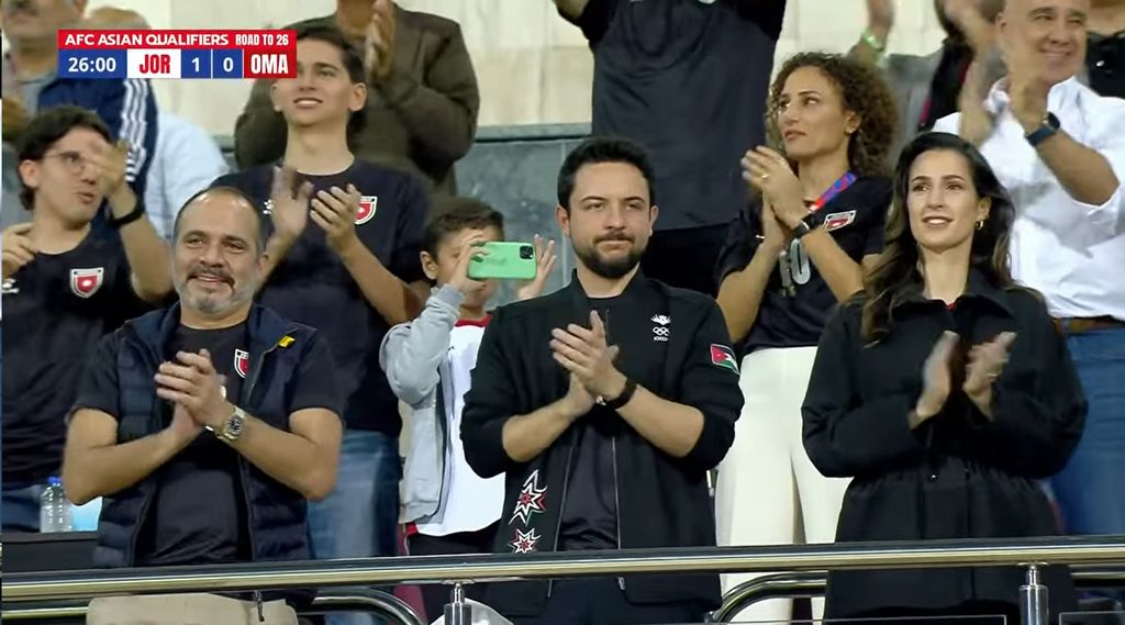 Crown Prince Hussein and Princess Rajwa applauding inside a football stadium