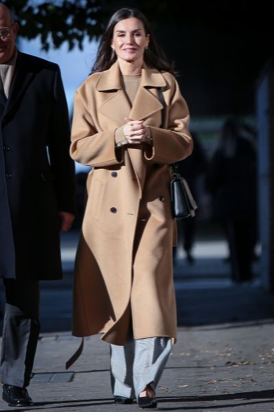Queen Letizia of Spain attended a meeting at FEDERs headquarters on January 17 in Madrid wearing Carolina Herrera camel coat