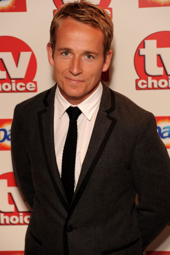 Jonnie Irwin smiling with blonde hair and a black suit arrives at the TV Choice Awards 2010 at The Dorchester 