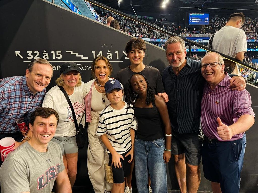 Mariska Hargitay, Peter Hermann, their three children, and the family of Katie Ledecky pose for a photo at the Olympic Games