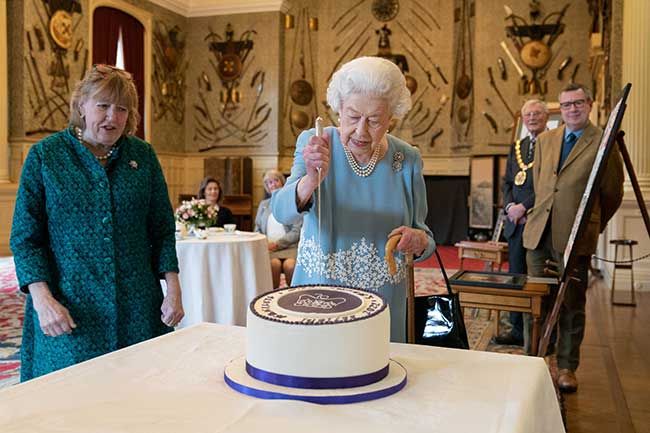The Queen cutting a Jubilee cake