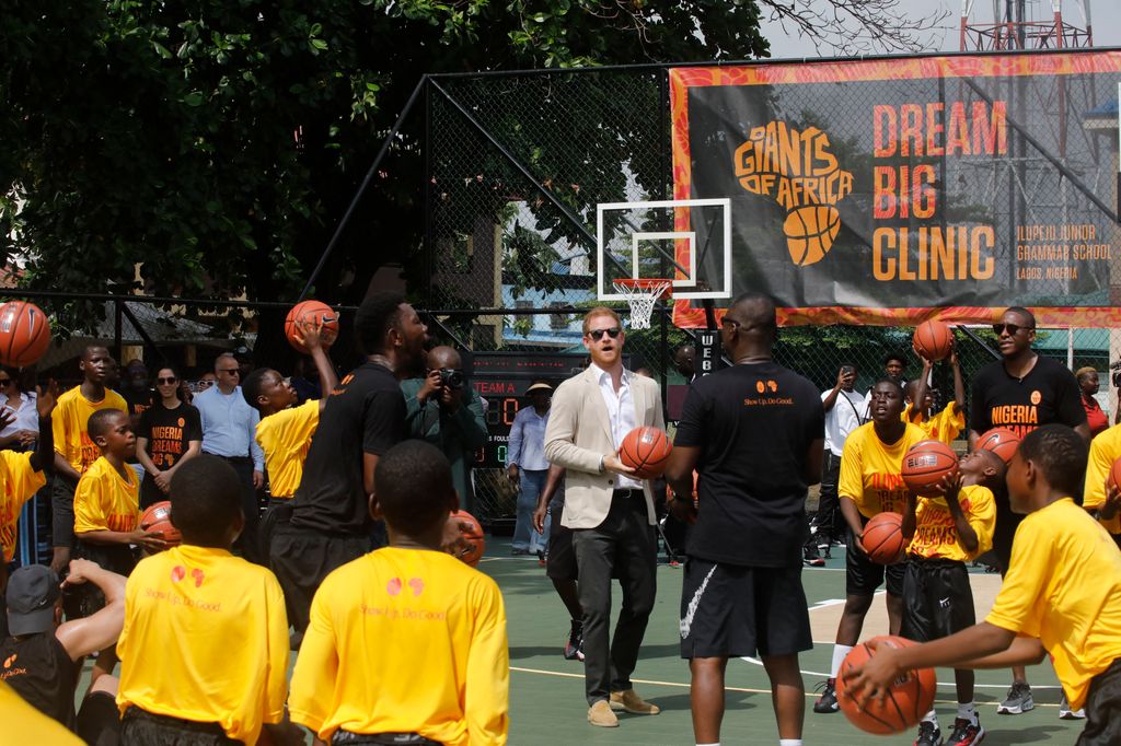 Britain's Prince Harry (C), Duke of Sussex, takes part in a basketball exhibition training match at Ilupeju Grammar School in Lagos 