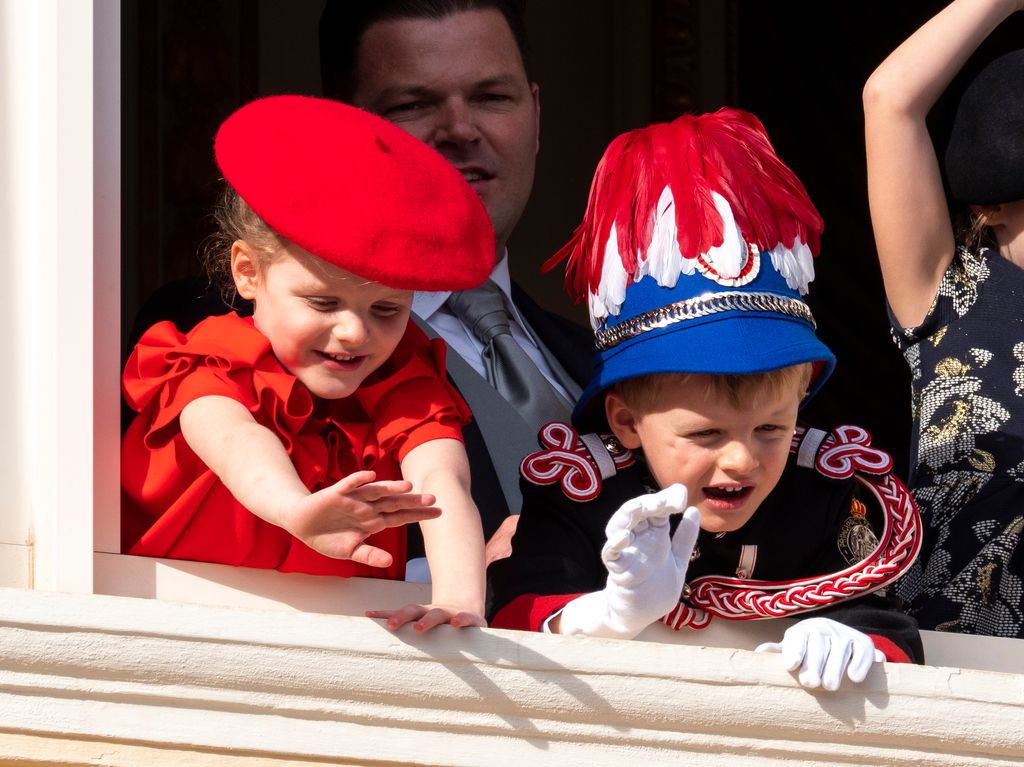 siblings waving out of window