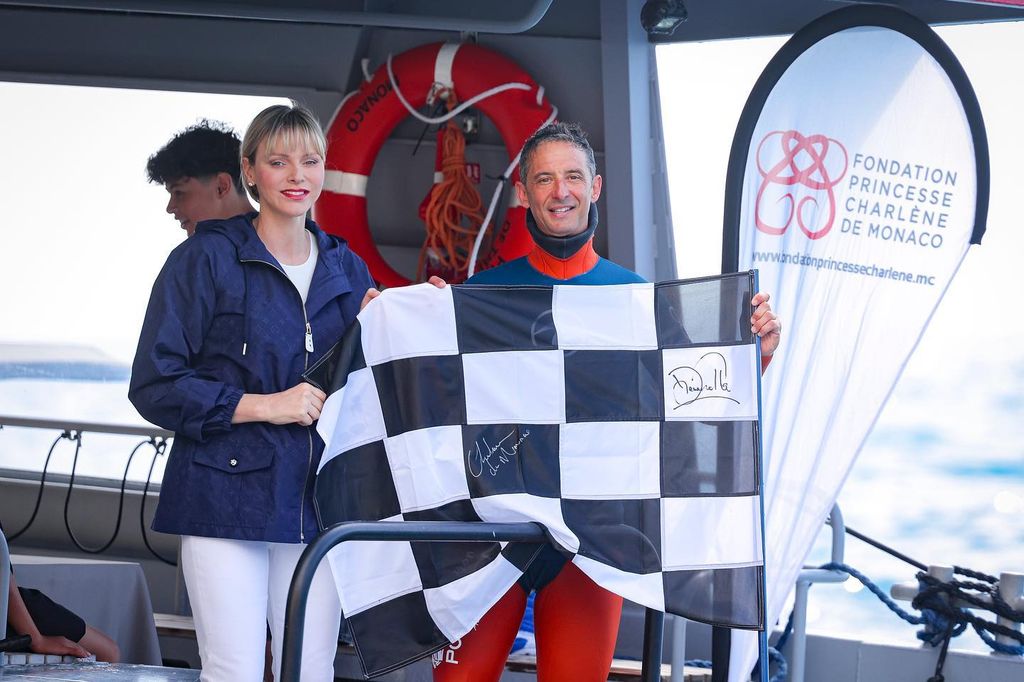 Princess Charlene on a boat in a Louis Vuitton anorak