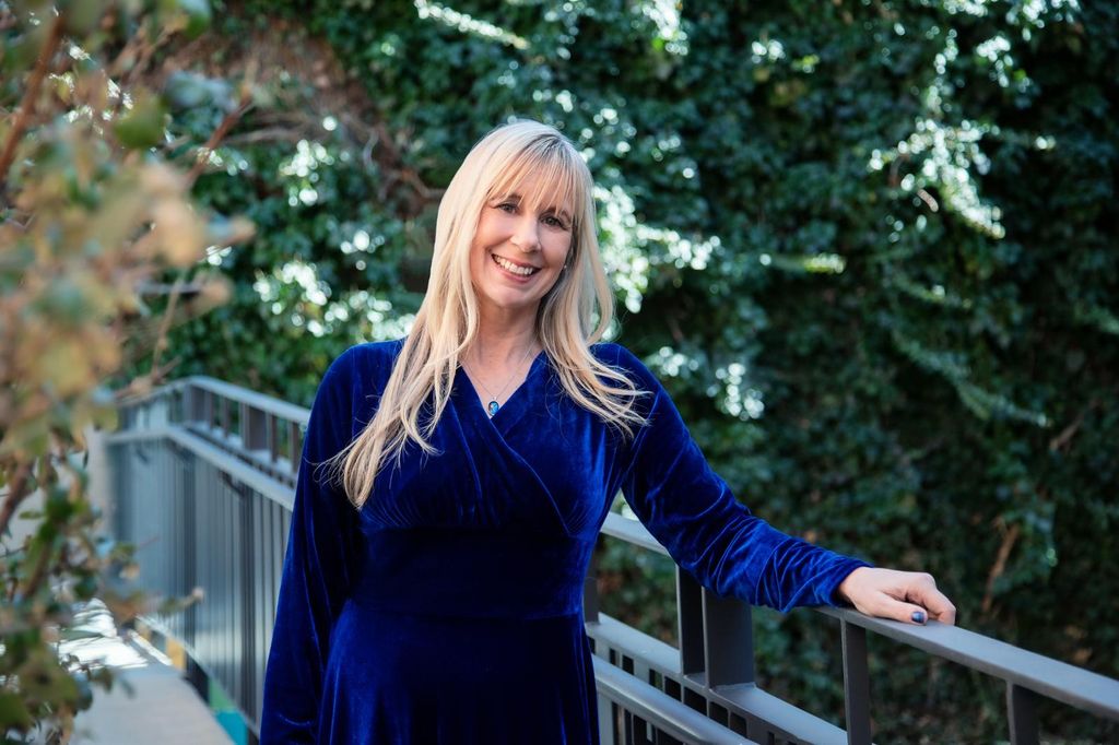 Theresa standing on a bridge