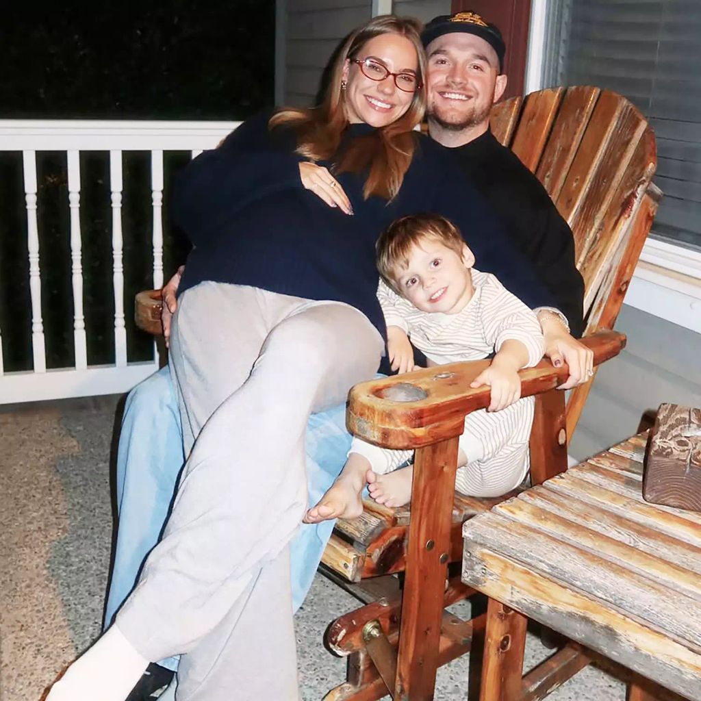 Emilie Kiser sits on husband Blake's lap with son Trigg in the corne