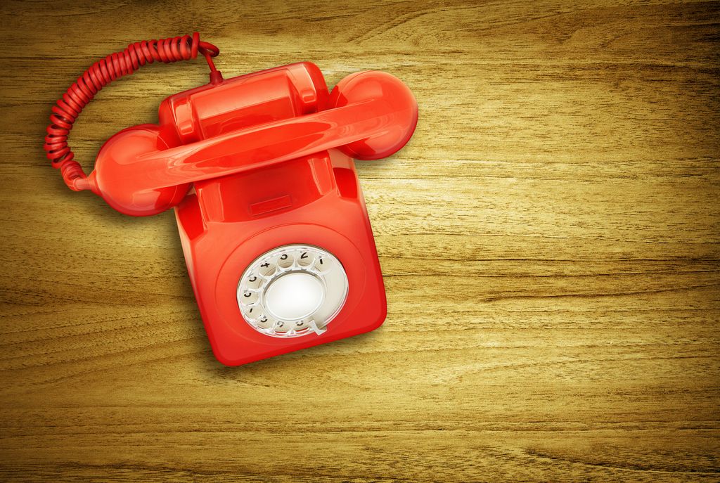 Overhead view of red retro telephone on desk
