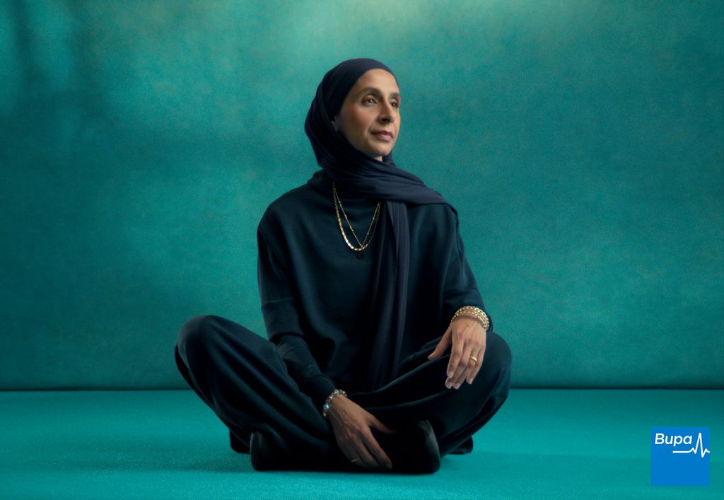 woman in headscarf sitting on ground