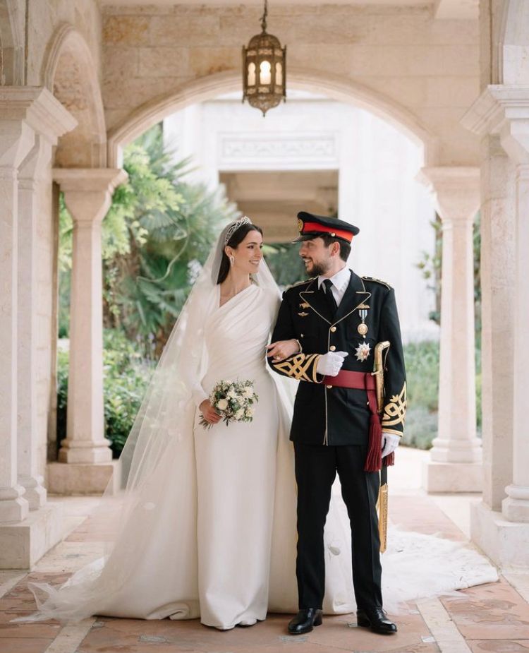 Crown Prince Hussein and Princess Rajwa smile at each other on their wedding day
