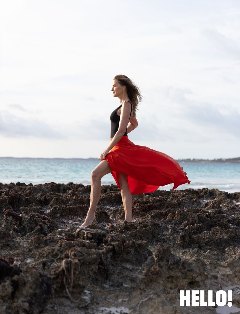 Woman on rocks looking out at sea