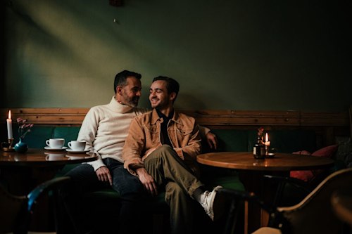 Gay male couple on a date in a cafe