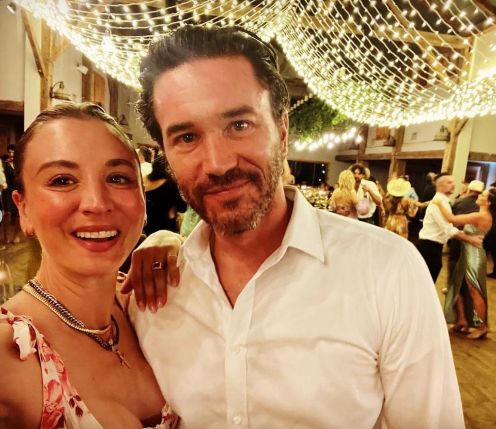 Photo shared by Tom Pelphrey on Instagram September 27 2023 where ehe and Kaley Cuoco are smiling for a selfie while attending a wedding.