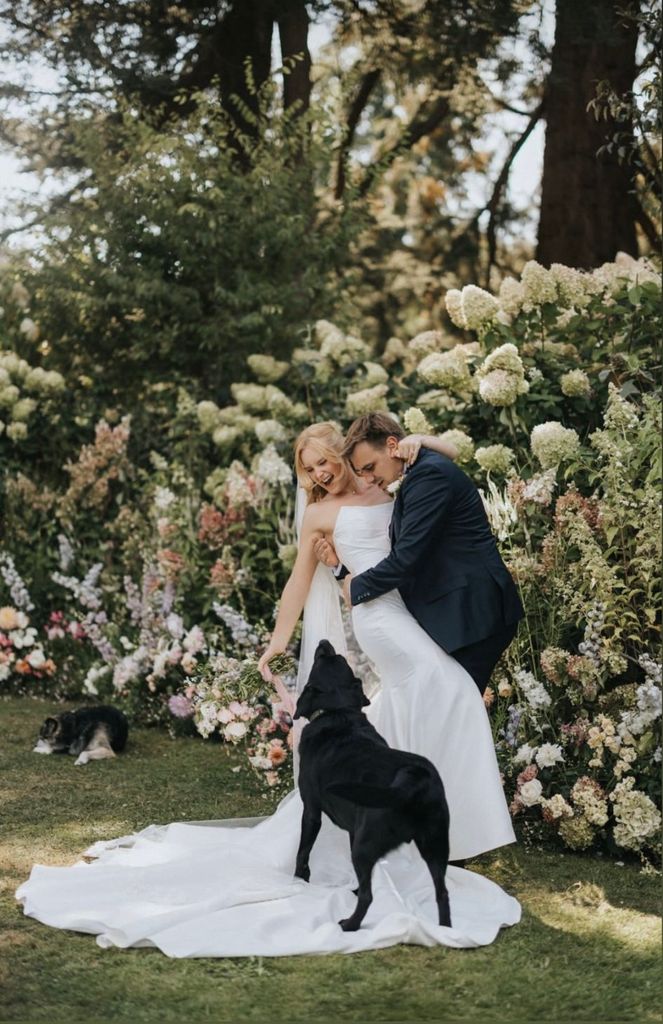 husband wife and dog on wedding day