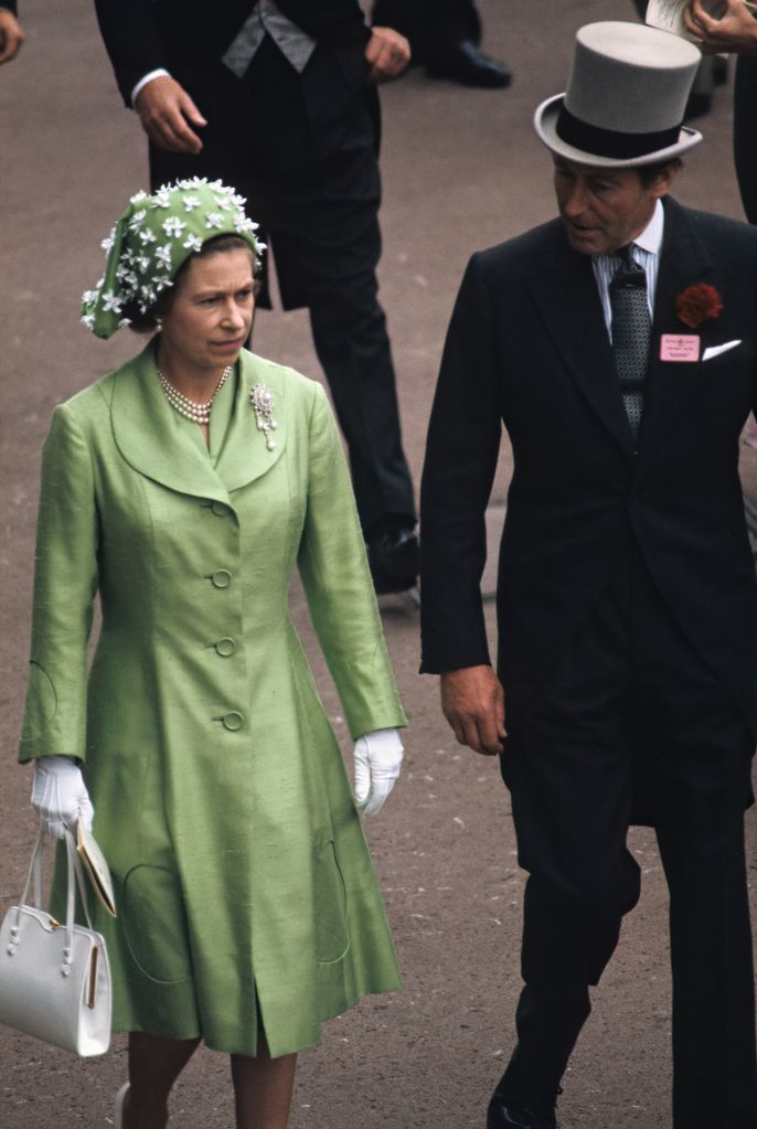 Queen Elizabeth II (1926 - 2022), accompanied by an unidentified man, arrives at the Royal Ascot at Ascot Racecourse, Ascot, England, 1973. (Photo by John Scott/Princess Diana Museum/Getty Images)