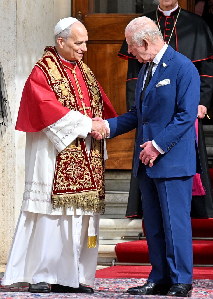 Pope Leo XIV and King Charles III shake hands in the San Damaso Courtyard