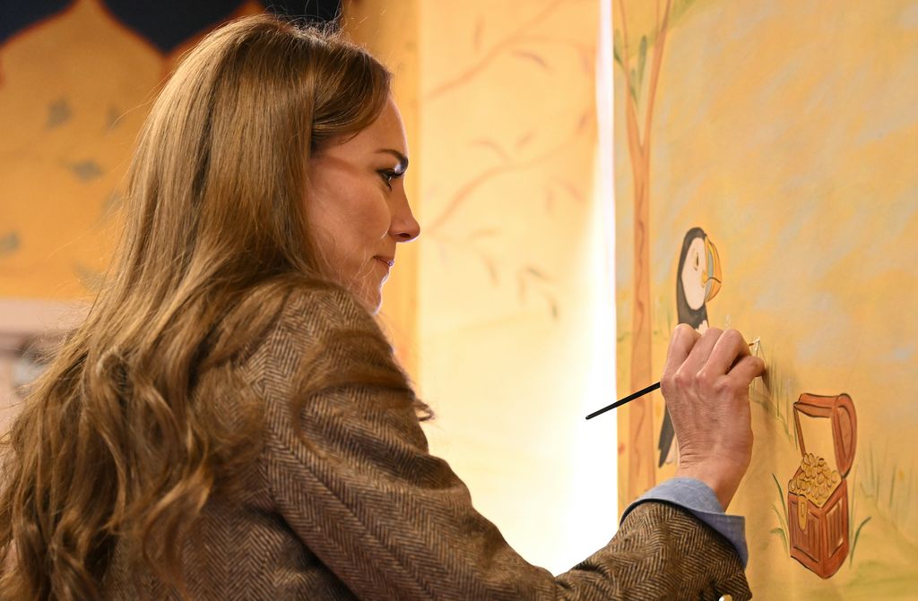 Kate Middleton paints detail on a mural