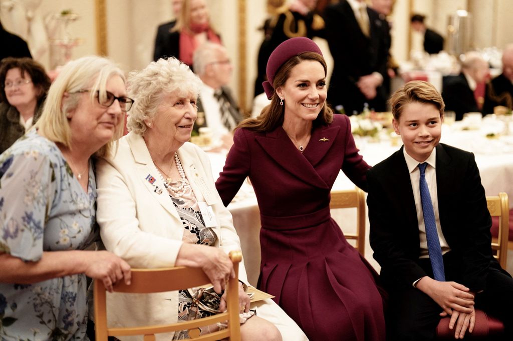 George posed for pictures at the party alongside his mother, Kate