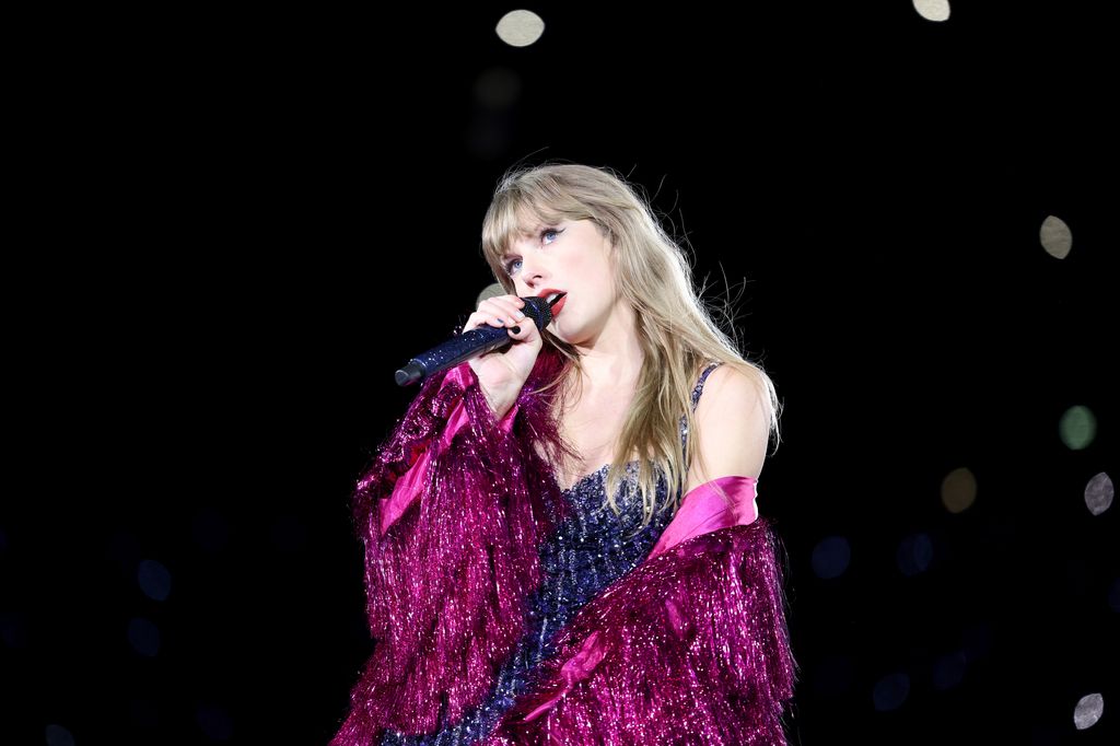 Taylor Swift wears tasselled purple jacket as she performs