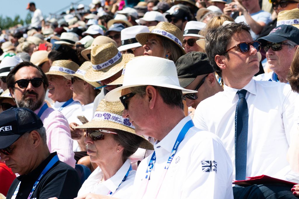 Princess Anne and Tim Laurence wearing hats at equestrian event