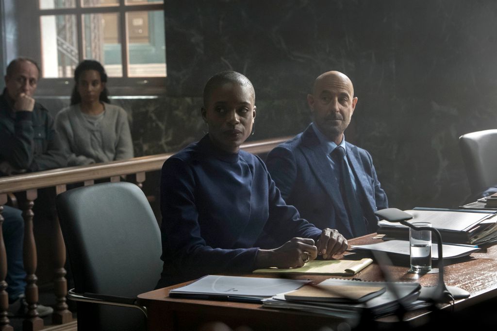 woman and man sitting at desk in court room