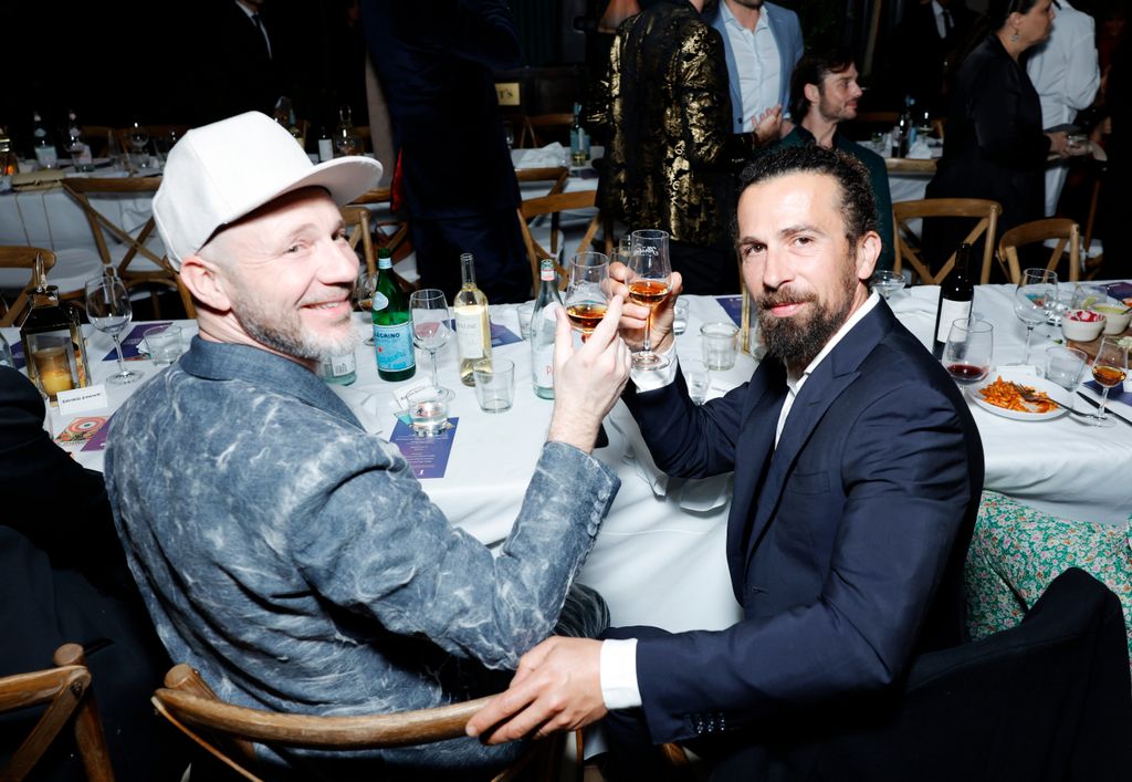Alberto Candiani and Alessandro Giuggioli sit together at a dinner table